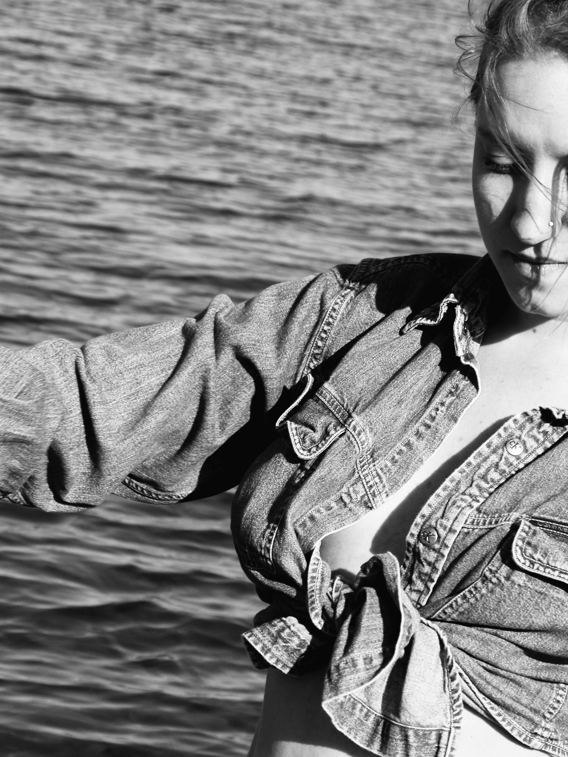 Black-and-white waterfront portrait of a young woman for Almost Home