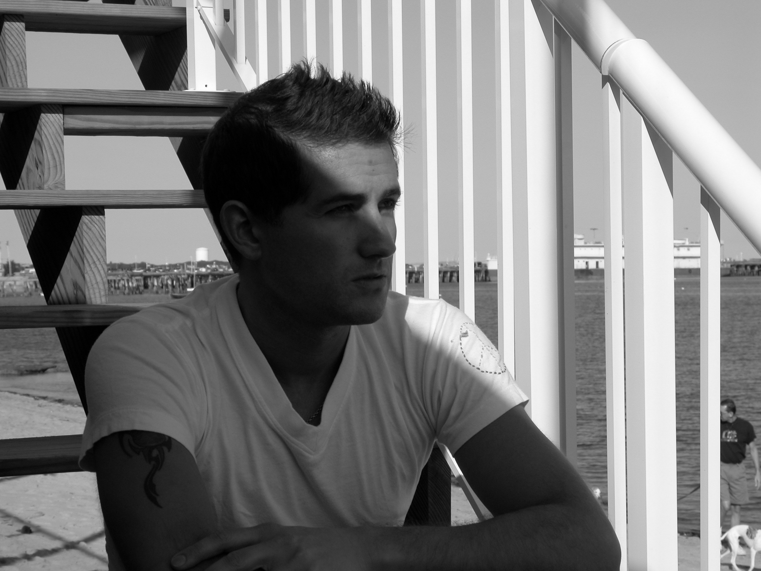 Black-and-white portrait of a young man by the Provincetown waterfront for Almost Home